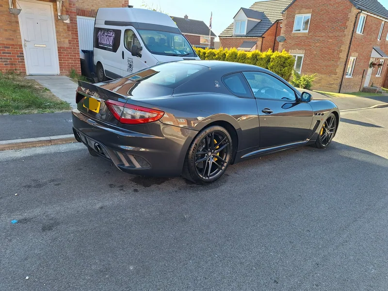 Maserati GranTurismo valeted at a customer’s home with the Valiant van in the background